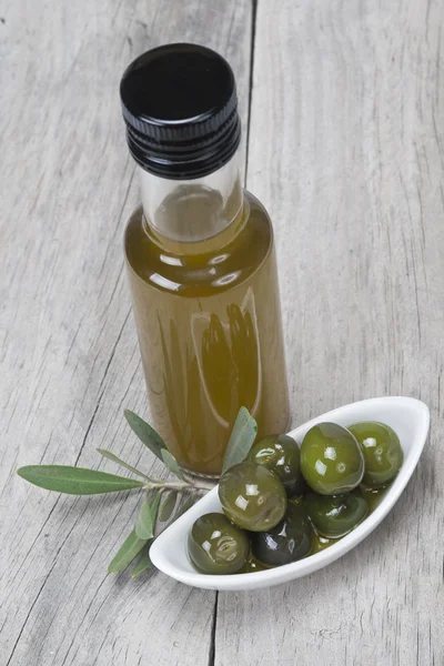 Olie van eerste persing en groene olijven — Stockfoto