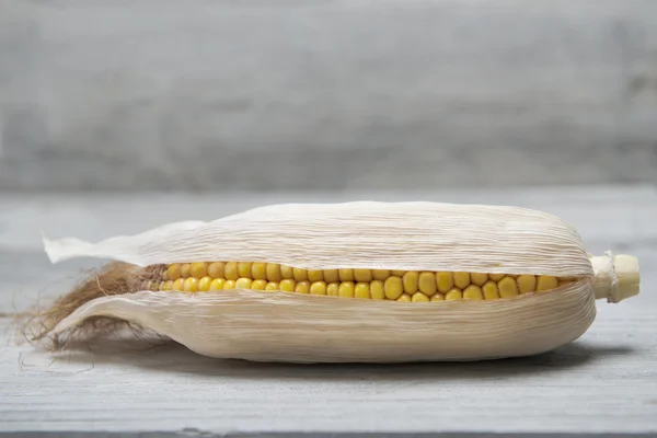 Corn ear on a wooden background — Stock Photo, Image