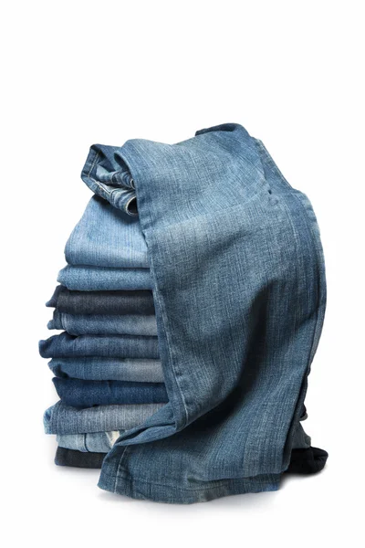 Stack of blue jeans over a white background — Stock Photo, Image