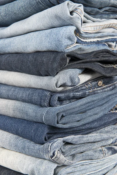 Stack of different old worn blue jeans — Stock Photo, Image
