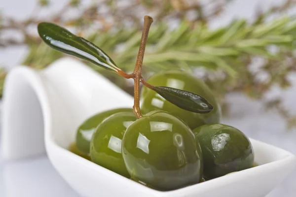 Green olives covered in oil — Stock Photo, Image