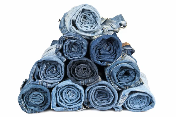 Rolled jeans arranged in a pyramid — Stock Photo, Image