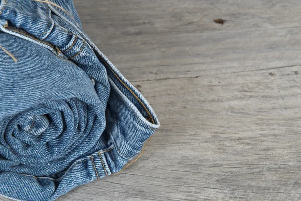 Rolled jeans arranged in a pyramid — Stock Photo, Image