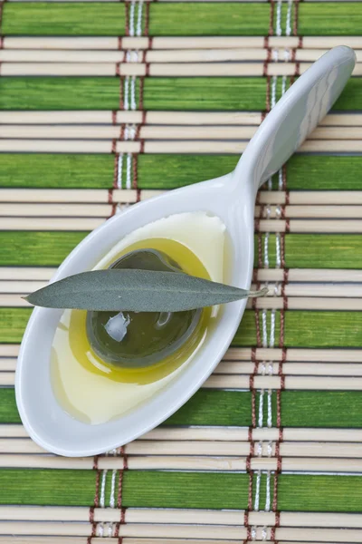 Olive in a china spoon — Stock Photo, Image