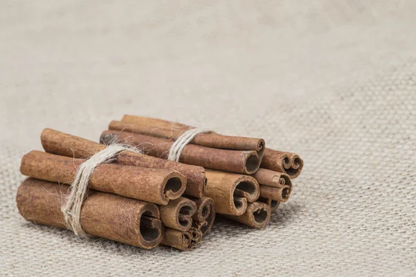 Cinnamon on a burlap — Stock Photo, Image