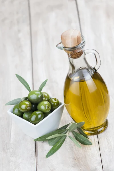 Olive oil on a wooden background — Stock Photo, Image