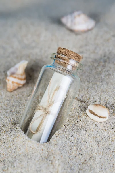 Message in a bottle on the sand of th beach — Stock Photo, Image