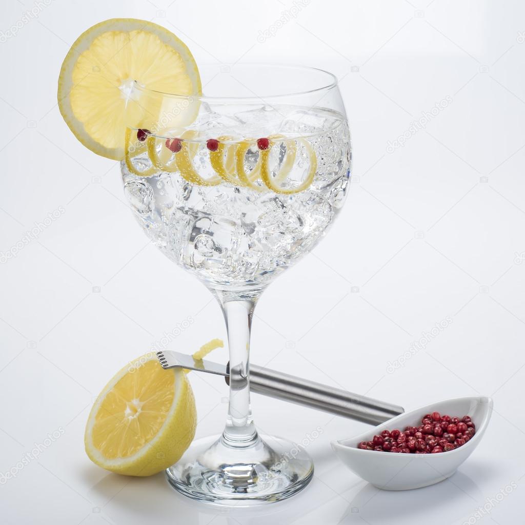 Gin and tonic with pink pepper and lemon twist