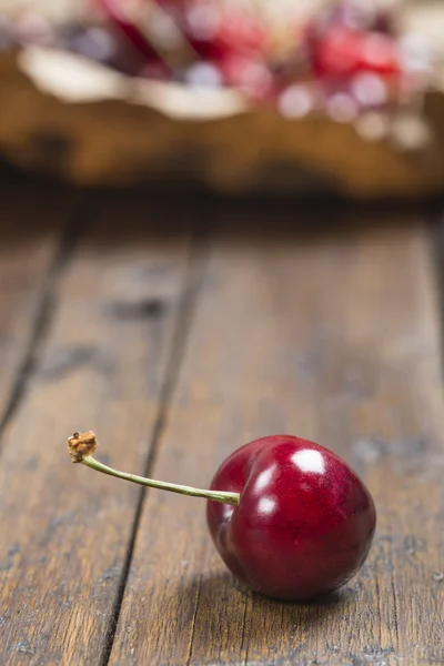A wrapping paper with cherries on the table — Stock Photo, Image