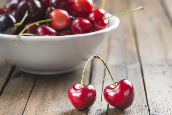 White bowl of cherries on the table — Stock Photo, Image