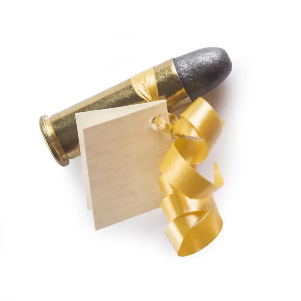 Bullet with a card decorated like a gift — Stock Photo, Image