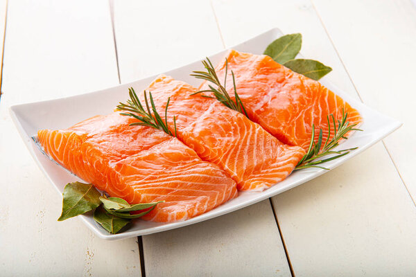 Fresh salmon fillets uncooked on the table of the kitchen