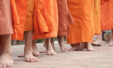 Monks walking on the street clipart
