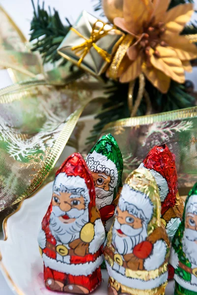 Santa shape chocolates under the christmas tree — Stock Photo, Image