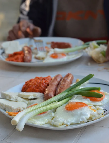 Аппетитный завтрак с яичницей и жареными колбасами — стоковое фото