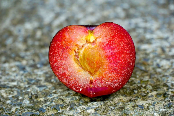 Juicy Red Plum Fruits Cut Half Concrete Background — Foto Stock