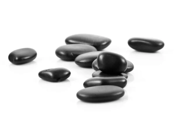 Black massage stones stacked, isolated. — Stock Photo, Image