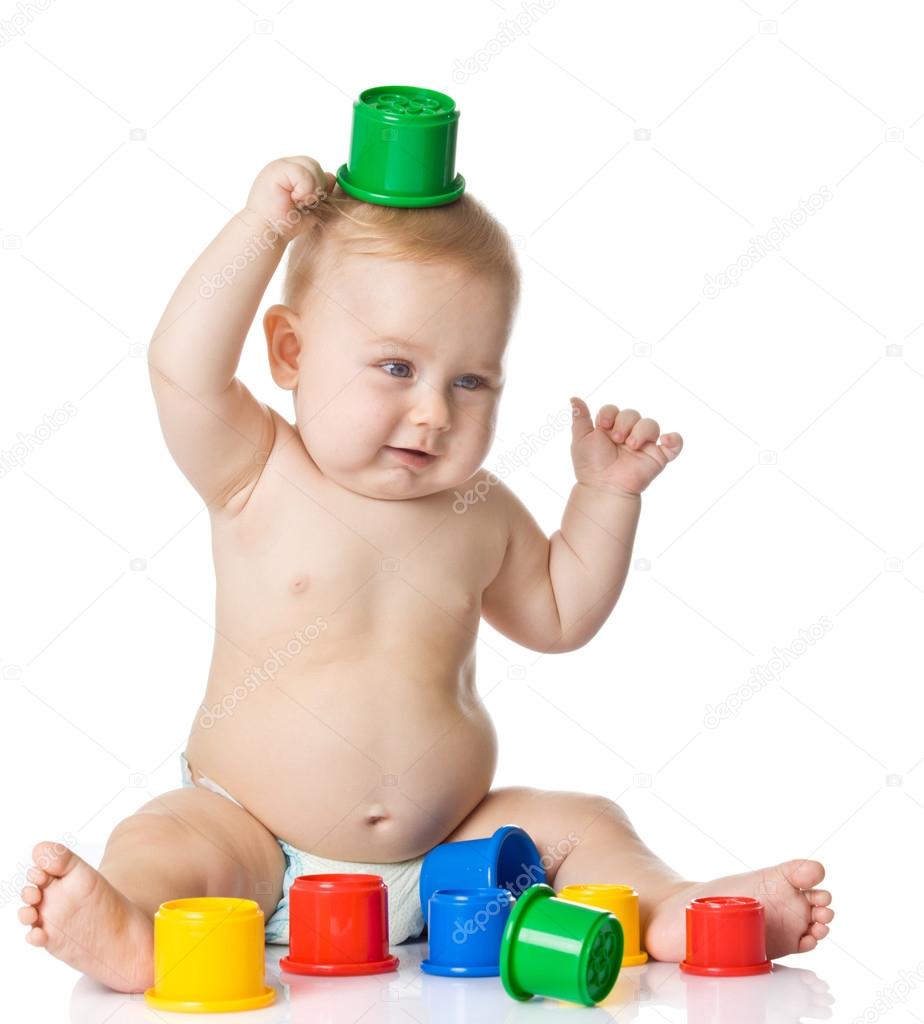 Baby playing with cup toys. Isolated on white background