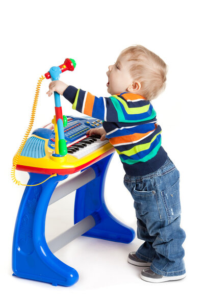 little boy and the keyboard on white background. funny boy baby.