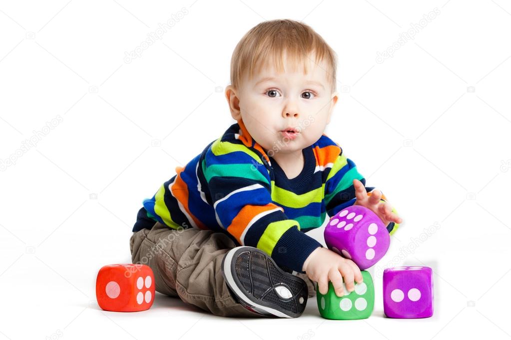 baby is playing with toys over white background. Funny little k