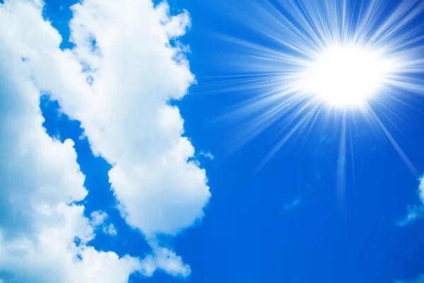 Blue sky with clouds and sun. White clouds in blue sky — Stock Photo, Image