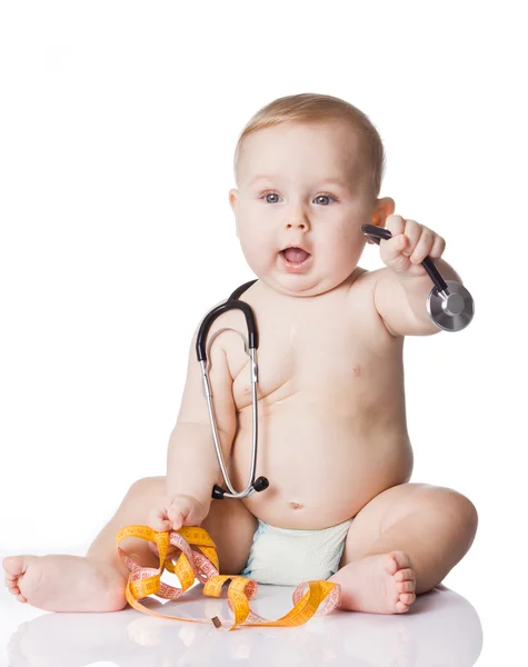 Sweet baby with stethoscope and measure tape on a white background Stock Image