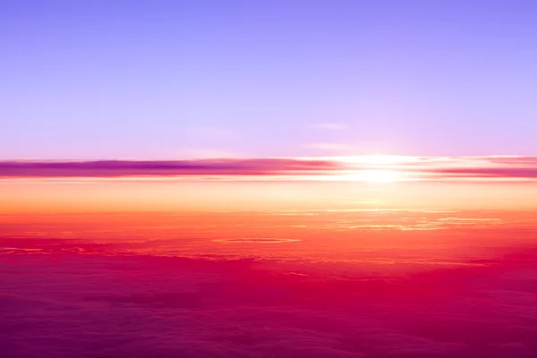 Sunset above clouds. View of sunset from airplane window — Stock Photo, Image