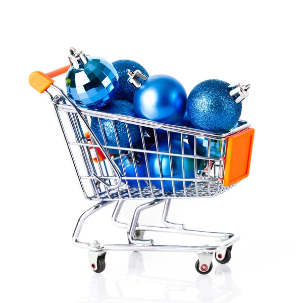 Shopping cart full of christmas balls isolated on white — Stock Photo, Image