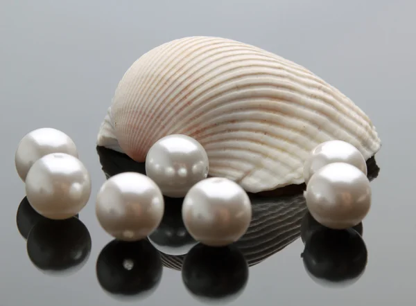 Seashell with pearls on black background — Stock Photo, Image