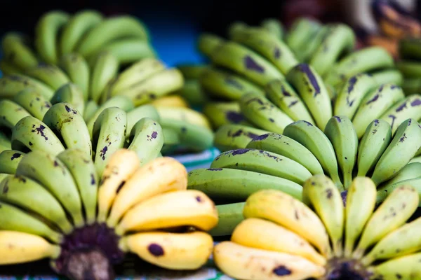 Plátanos verdes y amarillos frutas en el mercado —  Fotos de Stock