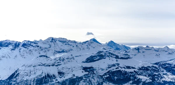 La cima de las montañas. Montañas altas bajo la nieve — Foto de Stock