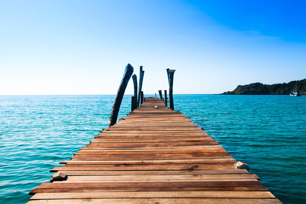 jetty that leads to an tropical island