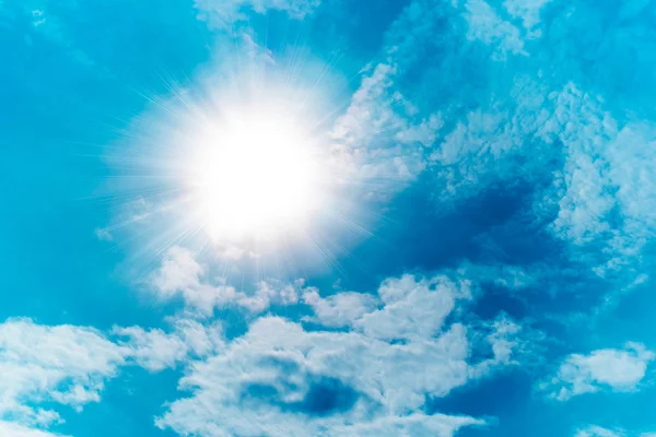 Blue sky with clouds and sun — Stock Photo, Image