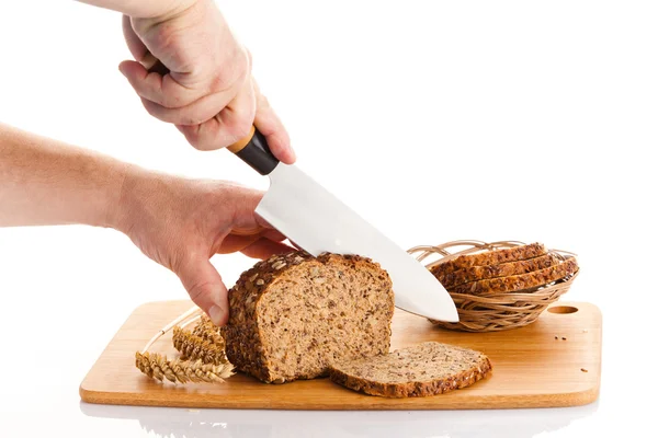 Slicing Bran Bread on a Cutting Board — Stock Photo, Image