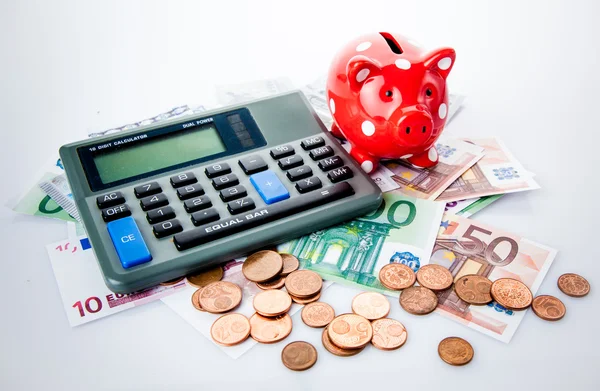 Red piggy bank with calculator — Stock Photo, Image