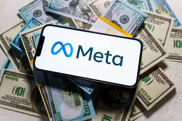 Berlin, Germany - February 02, 2022: iPhone 12 Pro Max with FACEBOOK META company logo  placed on US dollar bills