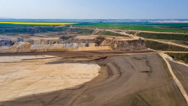 Panorama of Garzweiler surface mine in Germany with heavy machinery and power plant in the distance