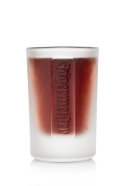 LONDON,UK - JULY 22, 2022: Shot glass of Jagermeister liqueur with original logo on white background.