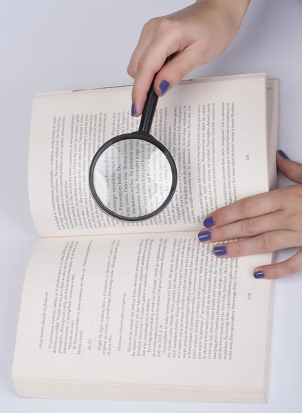 Magnifying glass over book — Stock Photo, Image