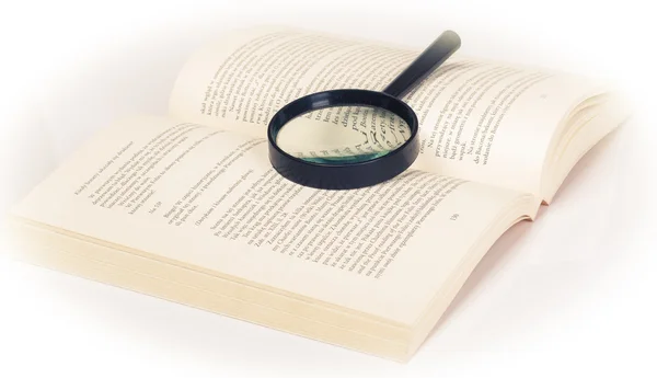 Magnifying glass over book — Stock Photo, Image