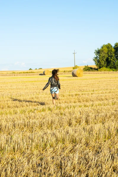 Brunette girl portrait and straw bale — Stock Photo, Image