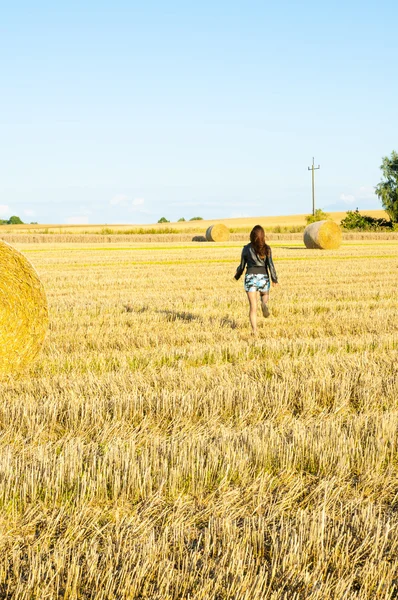 Brunette girl portrait and straw bale — Stock Photo, Image