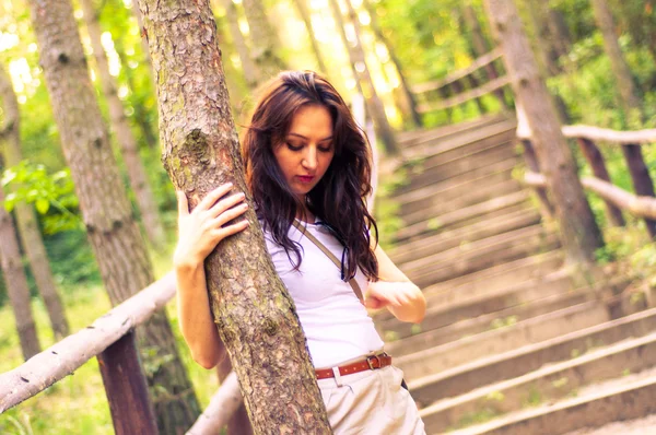 Girl walking through the forest pathway