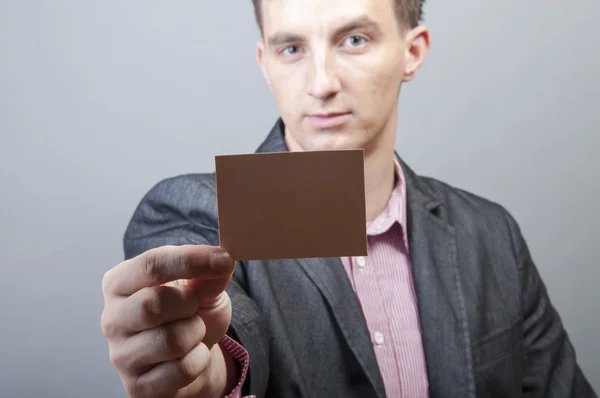 Businessman holding blank card — Stock Photo, Image