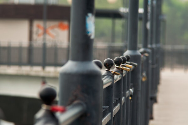 clipped a padlock to the bridge