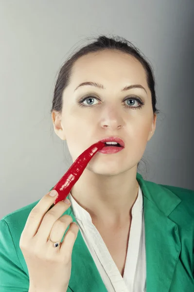 Businesswoman holding red chilli pepper — Stock Photo, Image