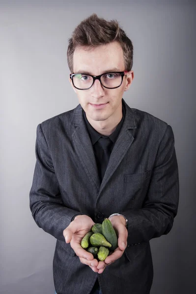 Vegetarian vegetable businessman holds in hands — Stock Photo, Image