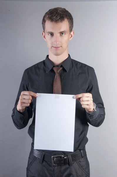 Young handsome businessman with blank card — Stock Photo, Image