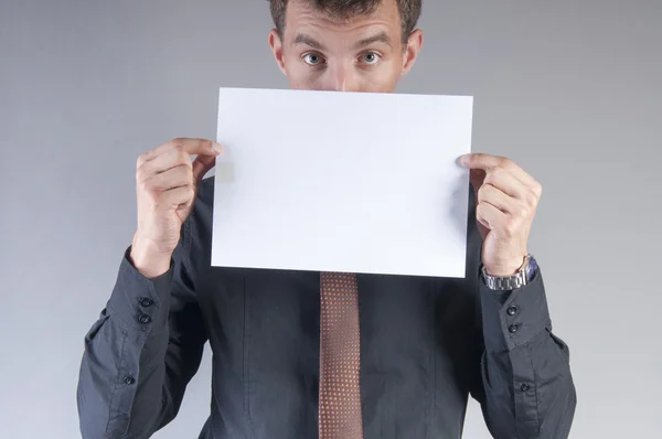 Young handsome businessman with blank card — Stock Photo, Image