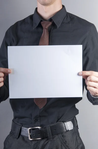 Young handsome businessman with blank card — Stock Photo, Image